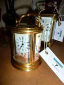 Small circular brass carriage clock with enamel dial and panels 10.5cm