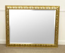Large bevel edge wall mirror in gilt frame with floral detail, 110 x 140cm