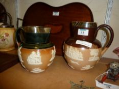 Two Edwardian Royal Doulton stoneware harvest jugs with hallmarked silver mounts