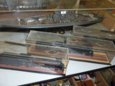 Model of a Japanese warship and three model trains