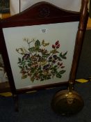 Mahogany fire screen with embroidered panel and a brass chestnut roaster