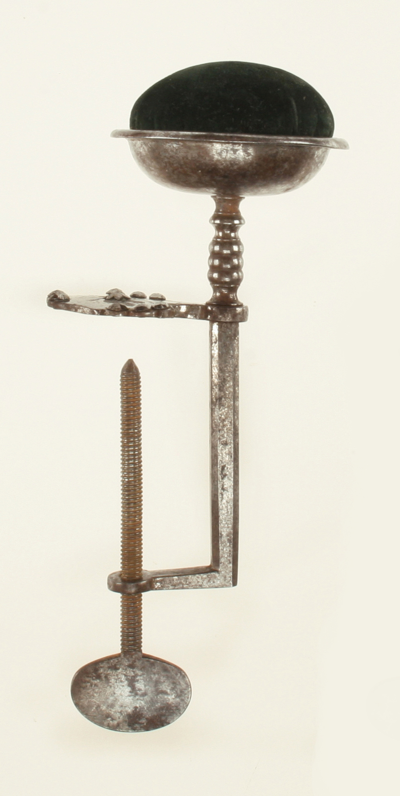 A fine 18c hand forged seamstresses table clamp pin cushion with attractive cut steel decoration