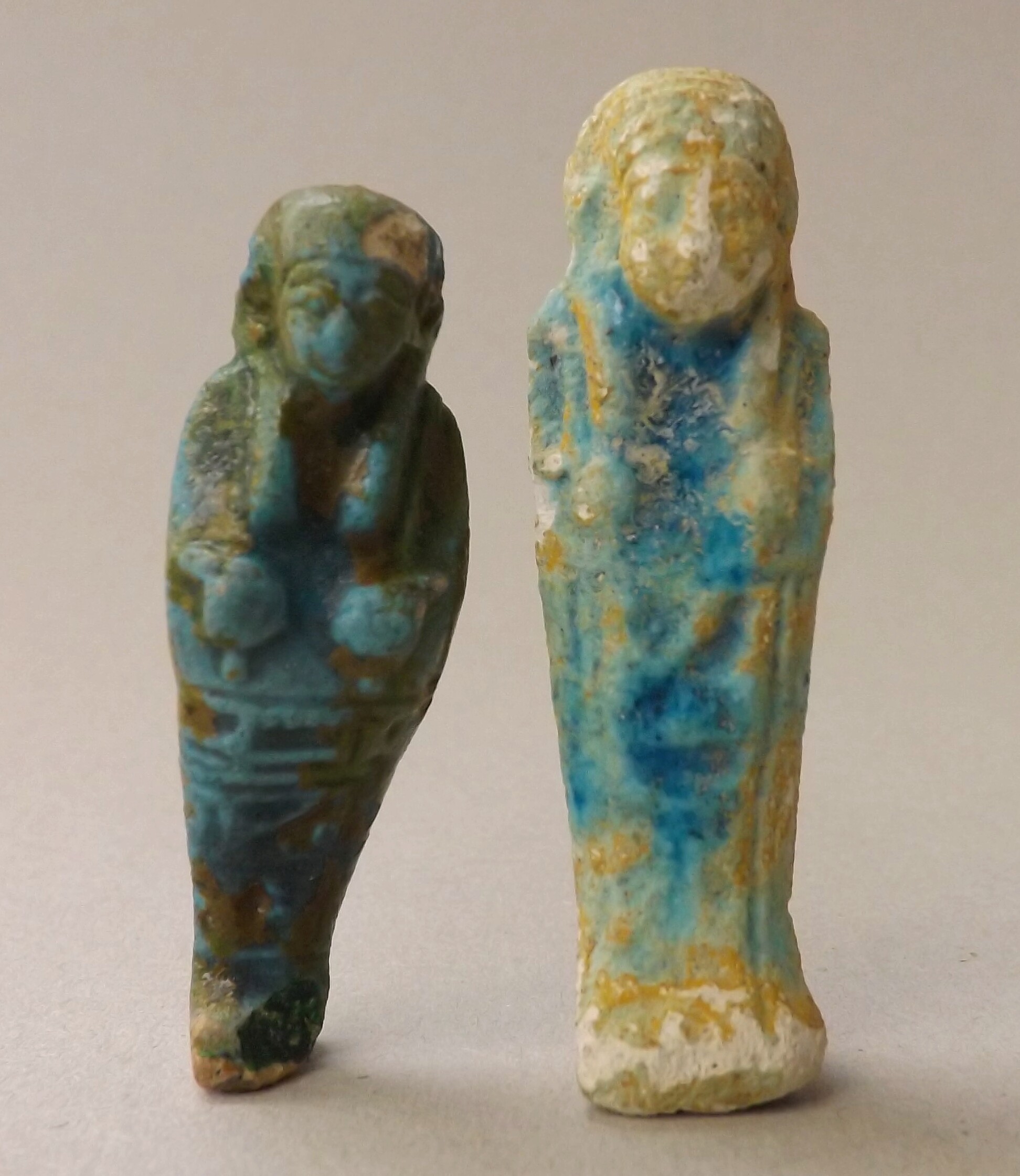 Two ancient Egyptian, small, turquoise glazed shabti, length of largest 5.5cm.