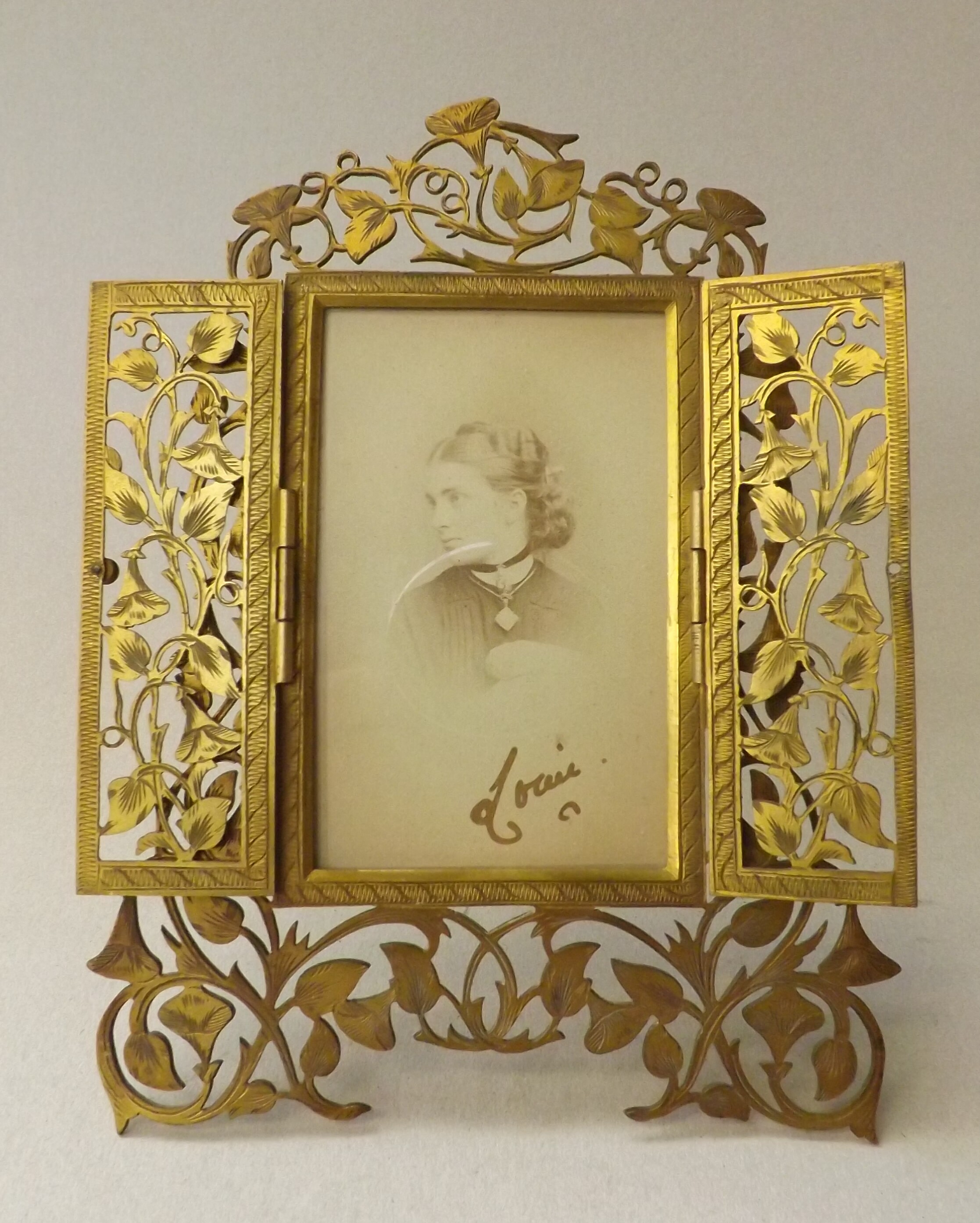 A good, Victorian, gilt bronze photograph frame, with pierced and engraved, convolvulus scrolls,