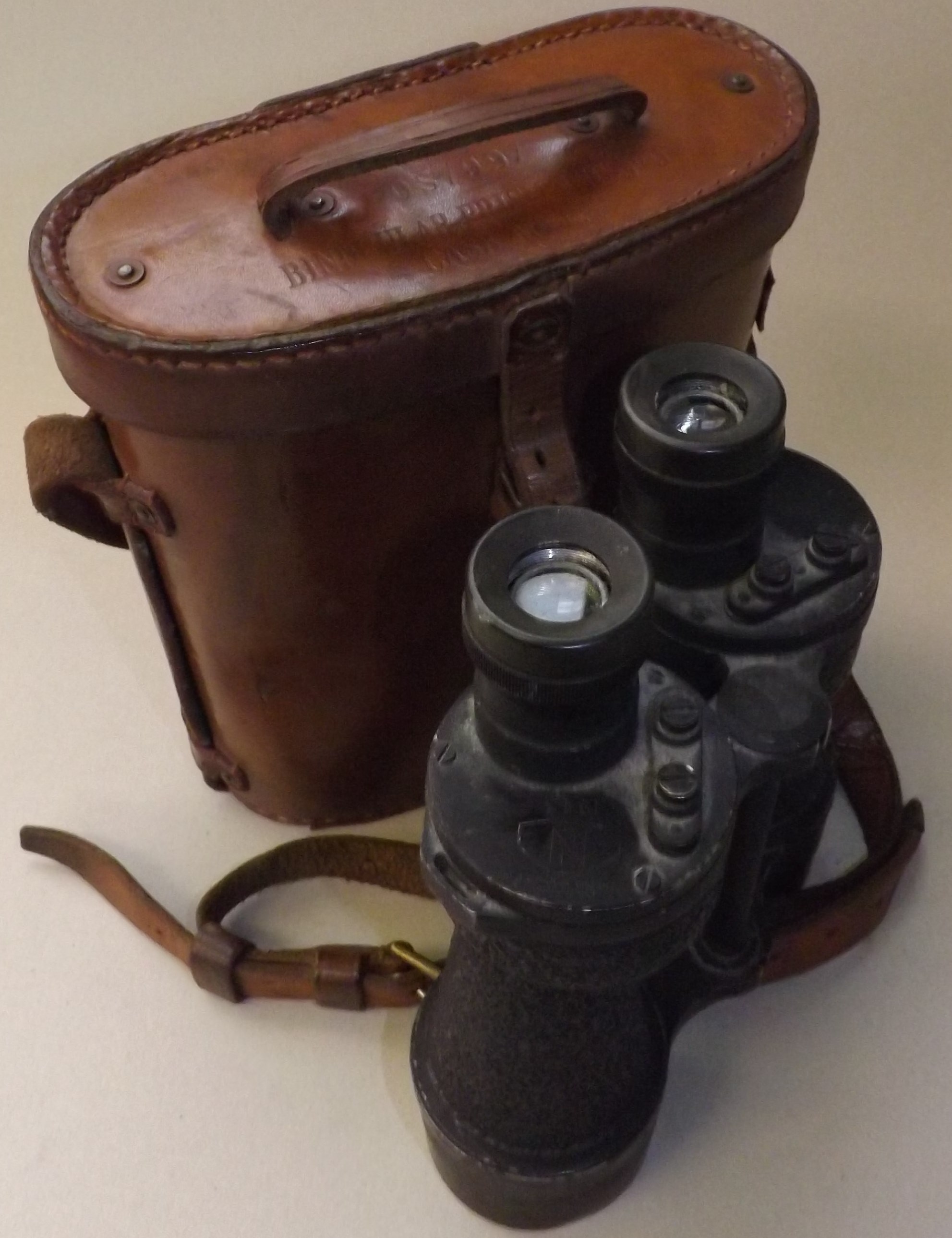 A pair of WWII military issue binoculars marked Bino Prism No. 5 NKIV4x7 and dated 1943 within