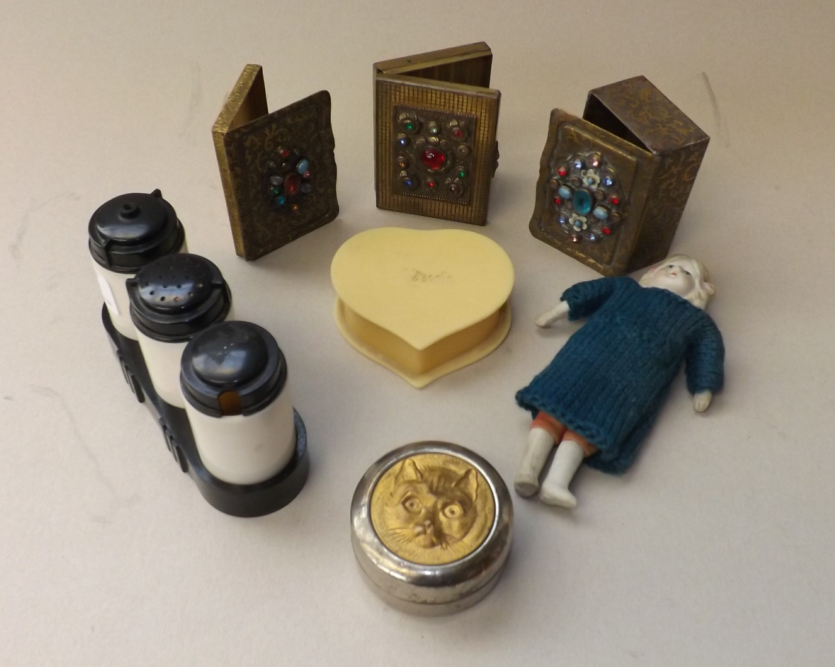 A 1940's plastic four piece condiment set in black and white, an ivoreen heart shaped stud box etc.