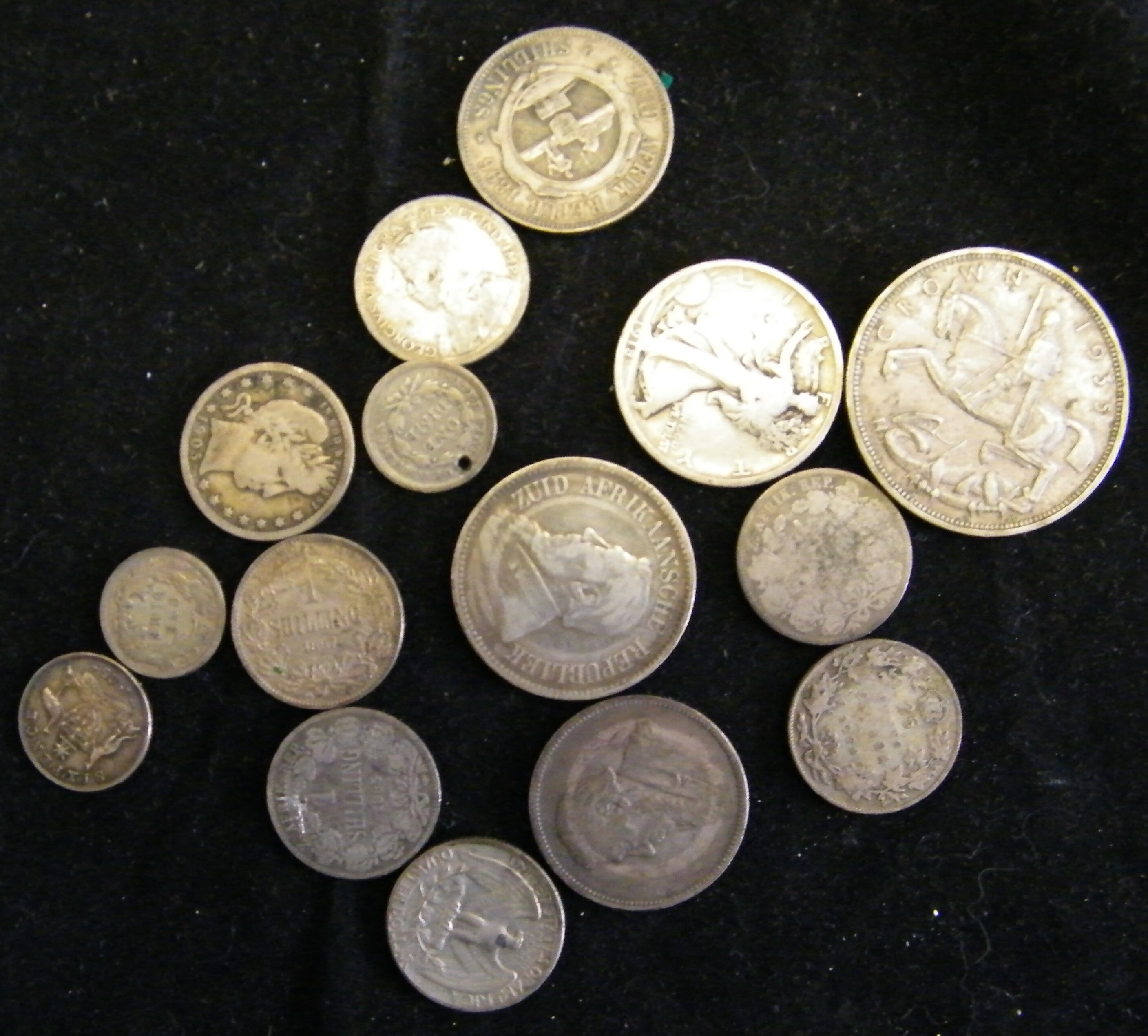 A 1935 crown and foreign silver coins.