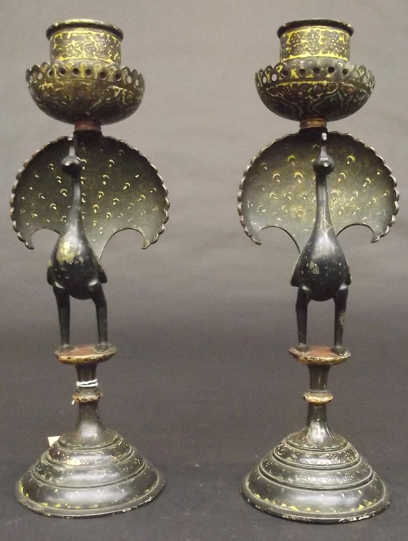 A pair of Indian brass and enamel candlesticks, the stems modelled as peacocks, height 30cm.