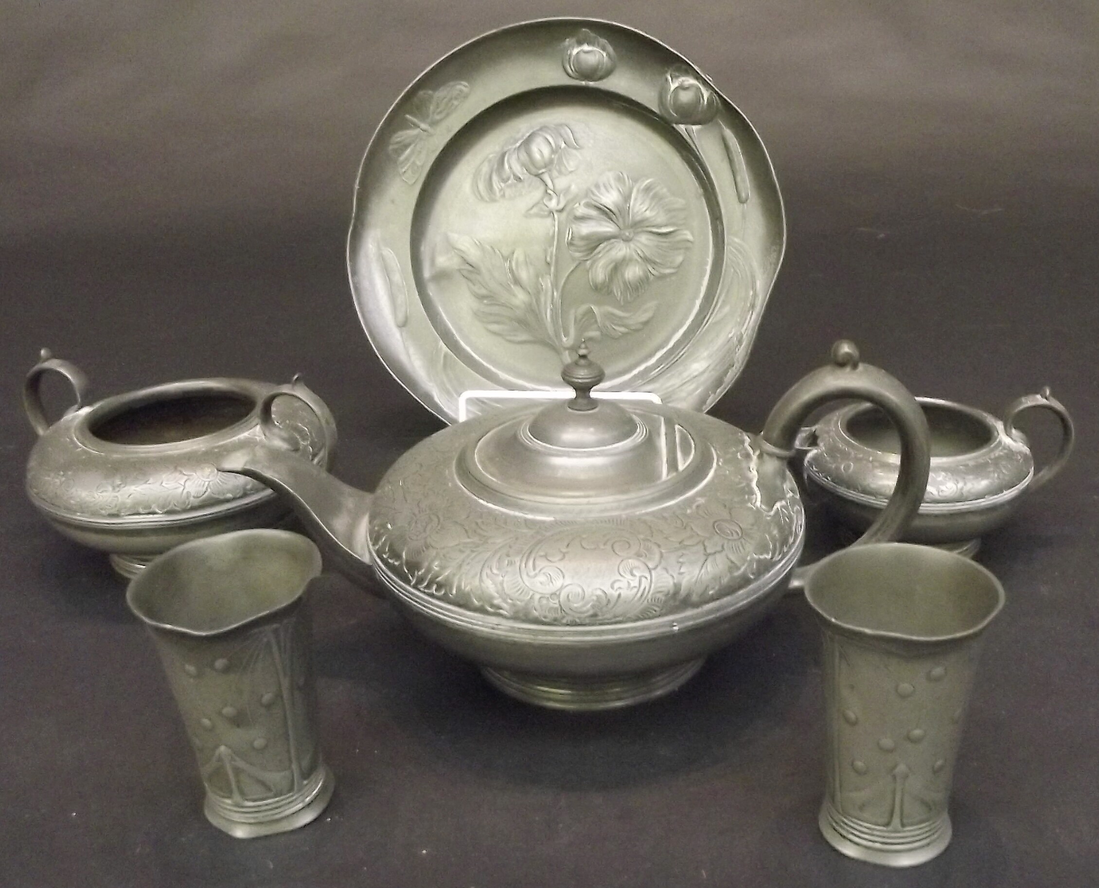 Pewter to include a pair of Art Nouveau tumblers, a dish cast with stylised flowers and a three