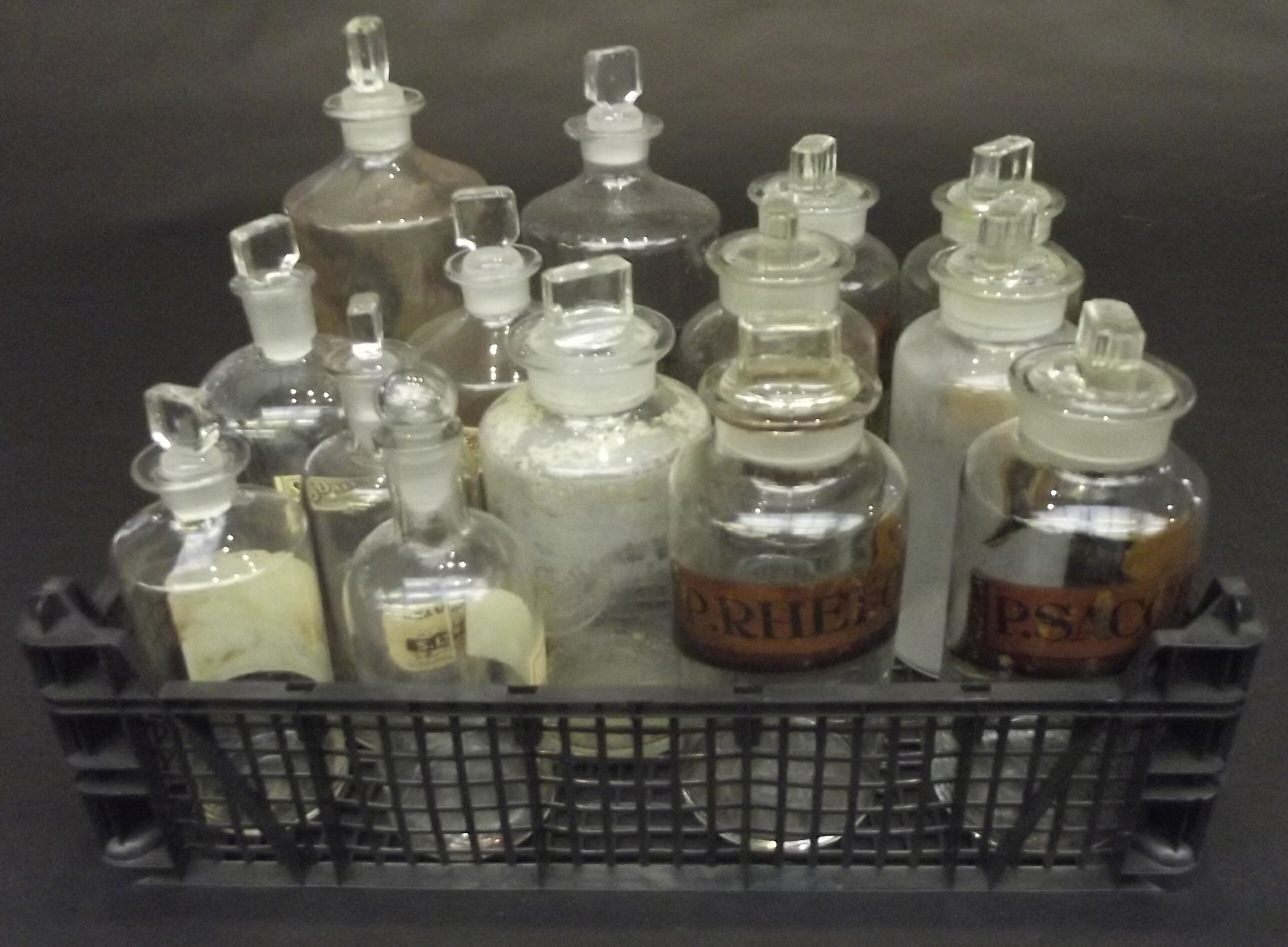 A set of six apothecary jars with gilt and painted inscriptions, and various other jars.