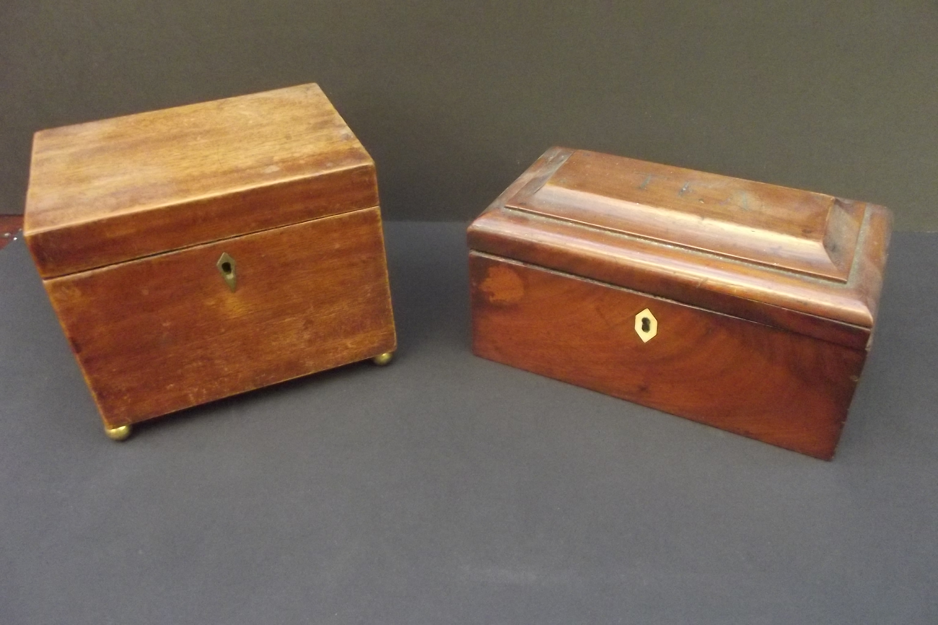 A 19th century mahogany cube tea caddy raised on brass ball feet and a mahogany tea caddy, the lid