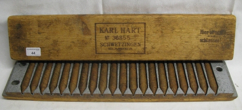A Karl Hart wood block cigar press/mould, the silver painted carved interior containing twenty