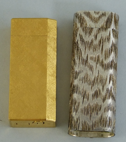 A Cartier gold plated gas pocket lighter, of oblong form with one canted corner and textured