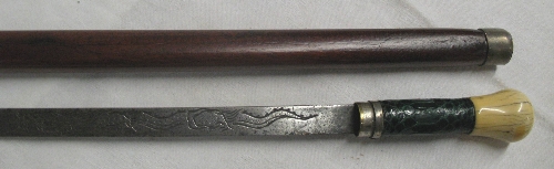 A sword stick, with 43.5cm single edged steel blade engraved with a dragon, the reptile skin covered