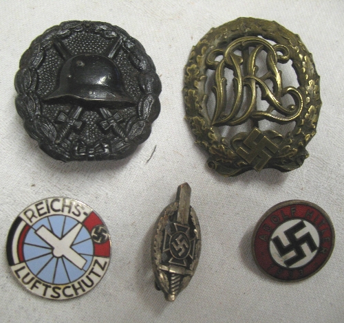 A World War I German wound badge, together with a Reich sport badge in bronze, a Veteran`s badge, an