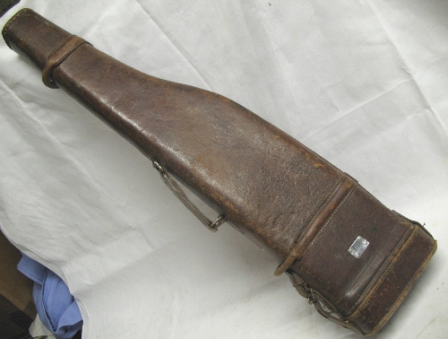 A stitched leather leg of mutton shotgun case, to take 72cm barrels with leather carrying handle,