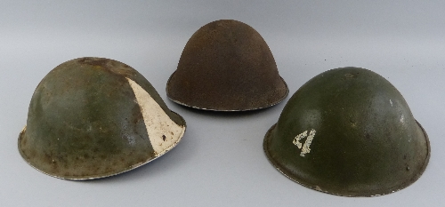 Three post World War II British steel helmets, two with green painted finish and one with liner (3)