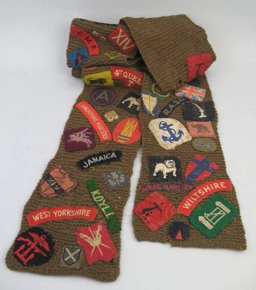 A World War II scarf, knitted from khaki wool and applied with over ninety different shoulder