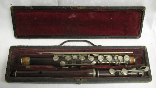 A 19th Century rosewood flute, stamped H Starck 8 Werrington St N W, in three sections with nickel