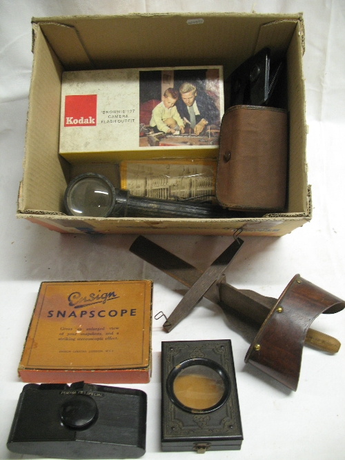 A hand held wooden stereoscope, 32cm long, a Japanned steel folding stereoscopic viewer, 12.5cm