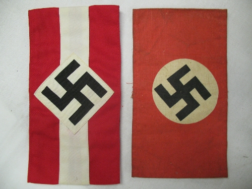 A Third Reich NSDAP arm band, printed cotton in red with white circle and angled Swastika,