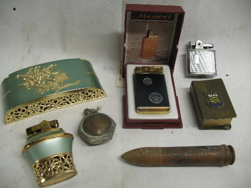 A Japanese Royal Musical butane pocket lighter, in box with instructions, 7cm high, a Japanese