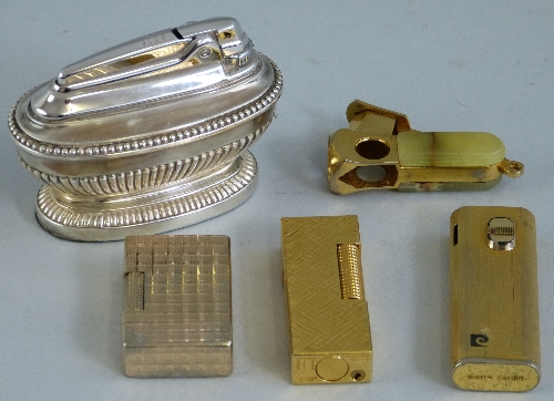 A Dunhill gold plated gas pocket lighter, of oblong form, 6.5cm high, two other gas pocket lighters,