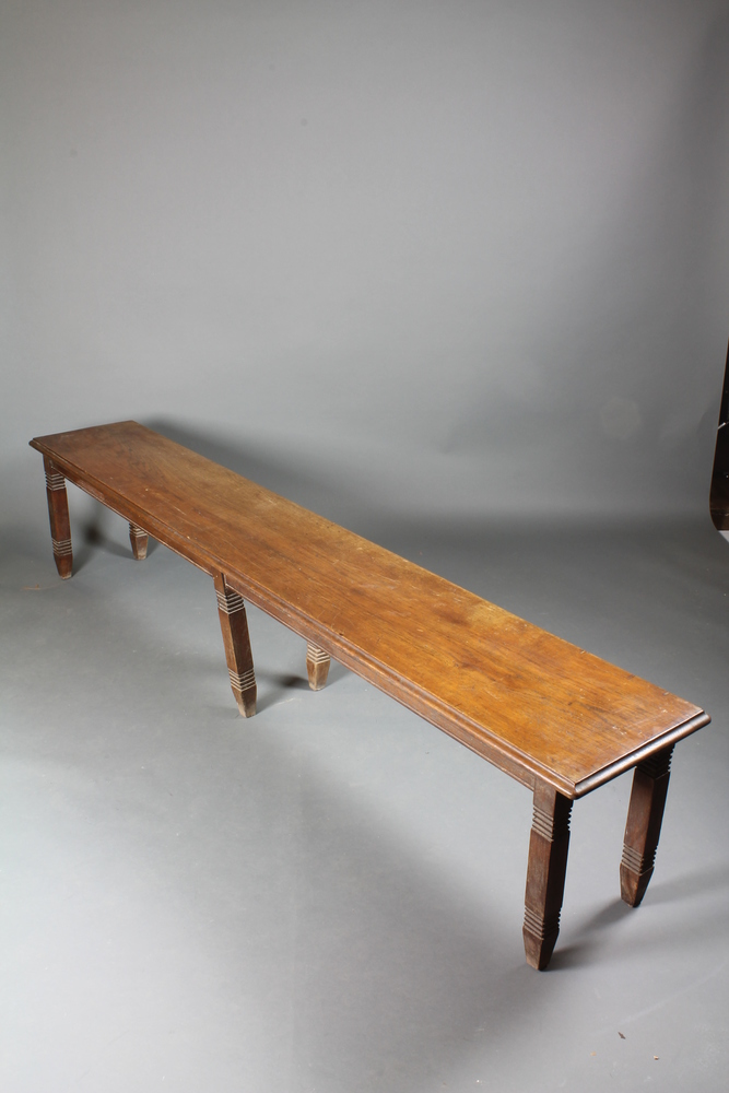 A late 19th Century Continental oak bench with moulded top on reeded tapered legs 19"h x 91.5"w x