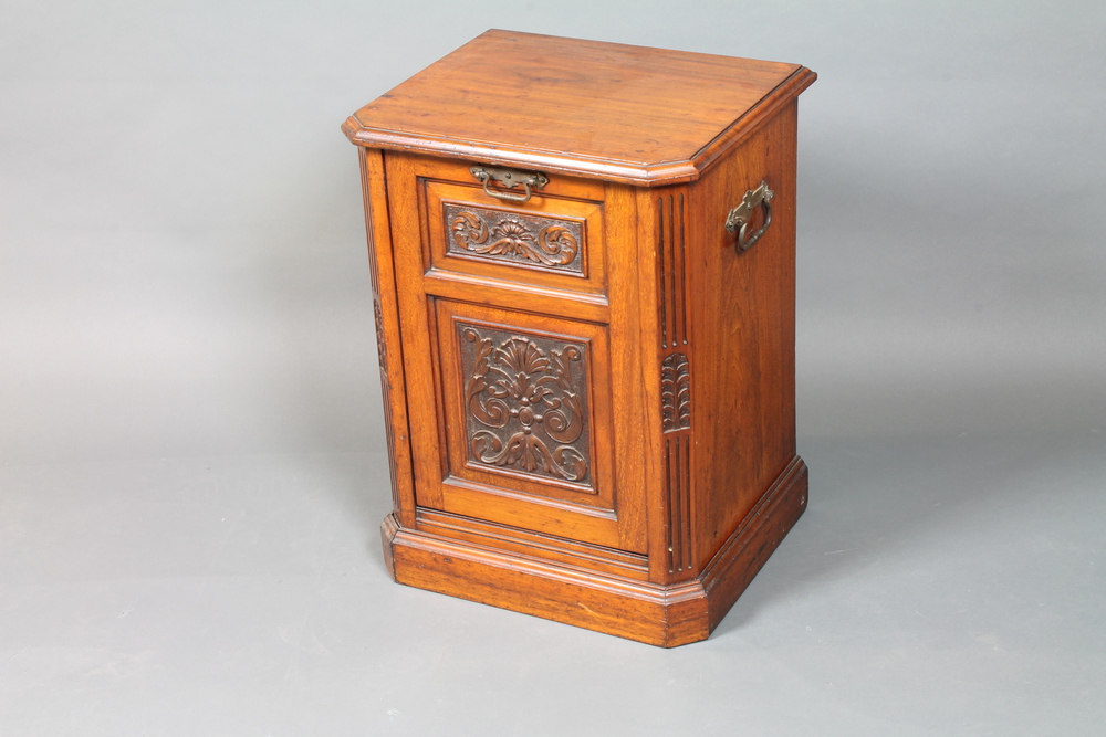 A late Victorian mahogany coal purdonium, the fall front drawer with foliate scroll relief carved