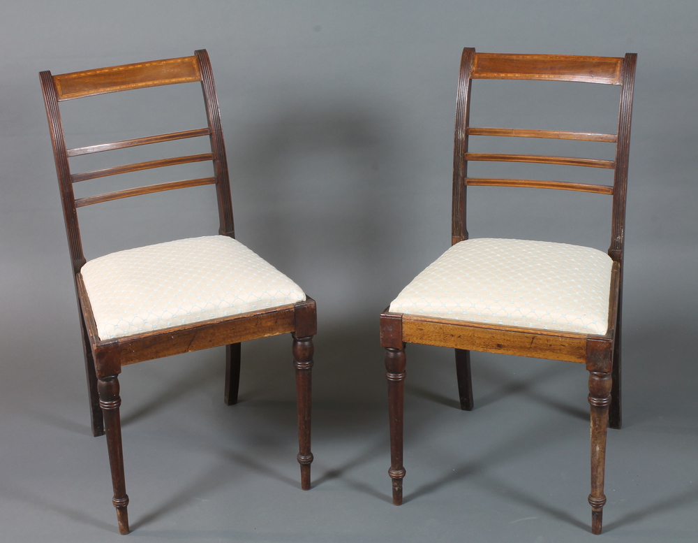 A pair of late George III mahogany dining chairs, satinwood crossbanded, fitted drop in seats on