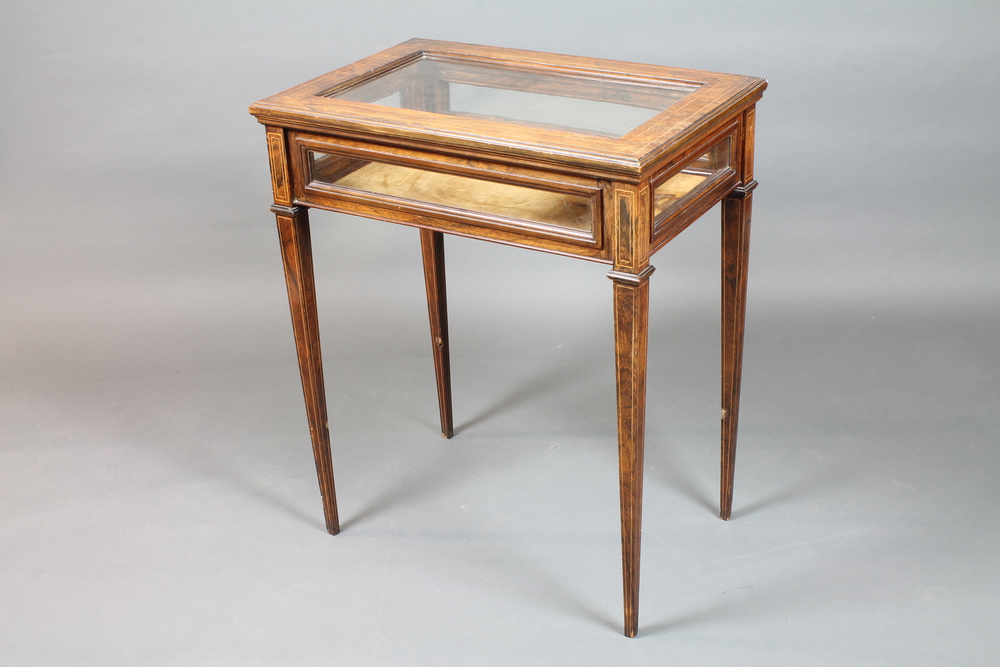 A late Victorian rosewood bijouterie table, boxwood line inlaid  with a hinged glazed top, raised on