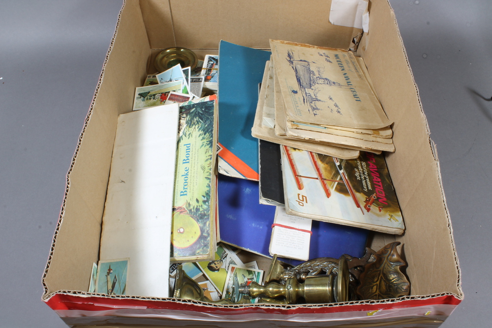 A small brass candlestick and a collection of tea cards etc