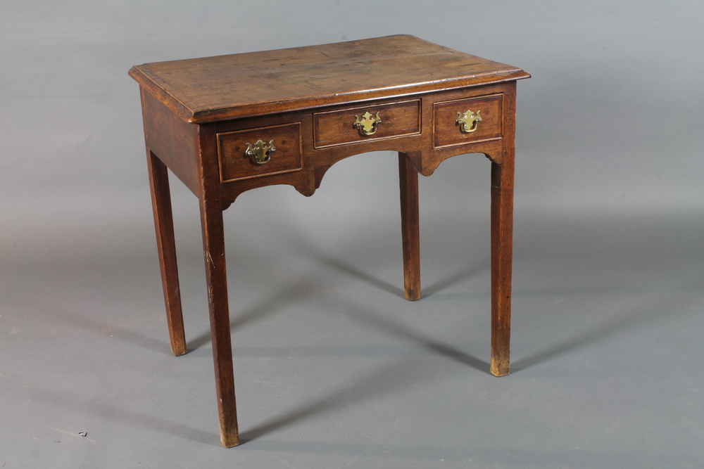 A George III North Country oak side table, mahogany cross  banded, fitted 3 frieze drawers with