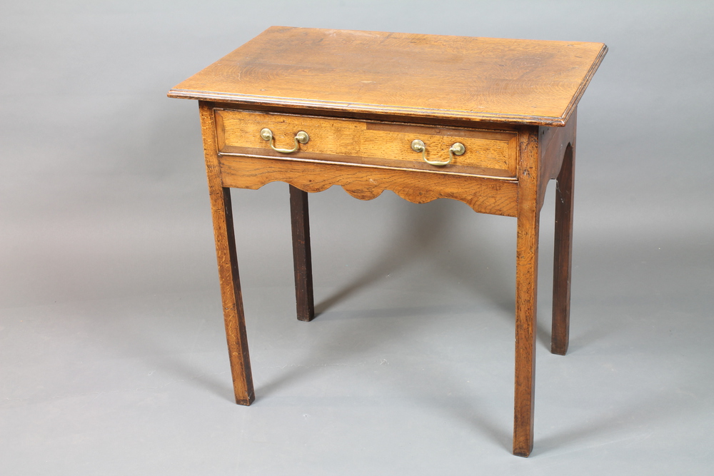 A George III North Country oak low boy, having moulded top above a frieze drawer with shaped apron