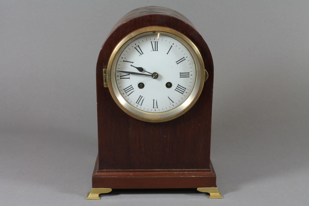 An Edwardian mahogany mantel clock, having an arched top  case, set Roman enamelled dial and 8 day