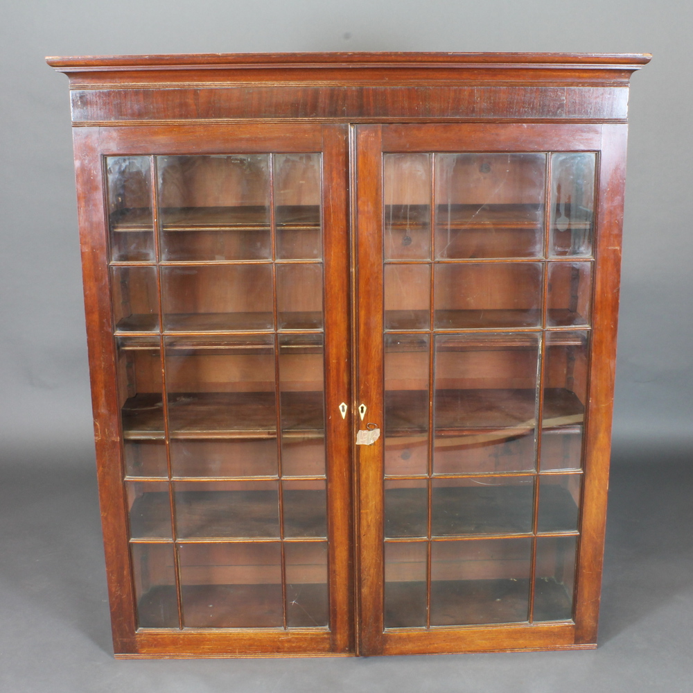 A 19th Century mahogany bookcase top with moulded cornice,  the shelved interior enclosed by