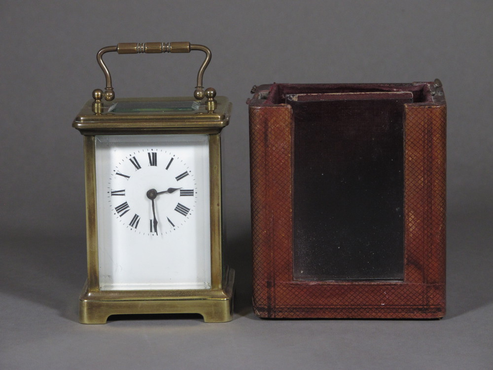 A 19th Century French 8 day carriage clock with enamelled dial  and Roman numerals contained in a