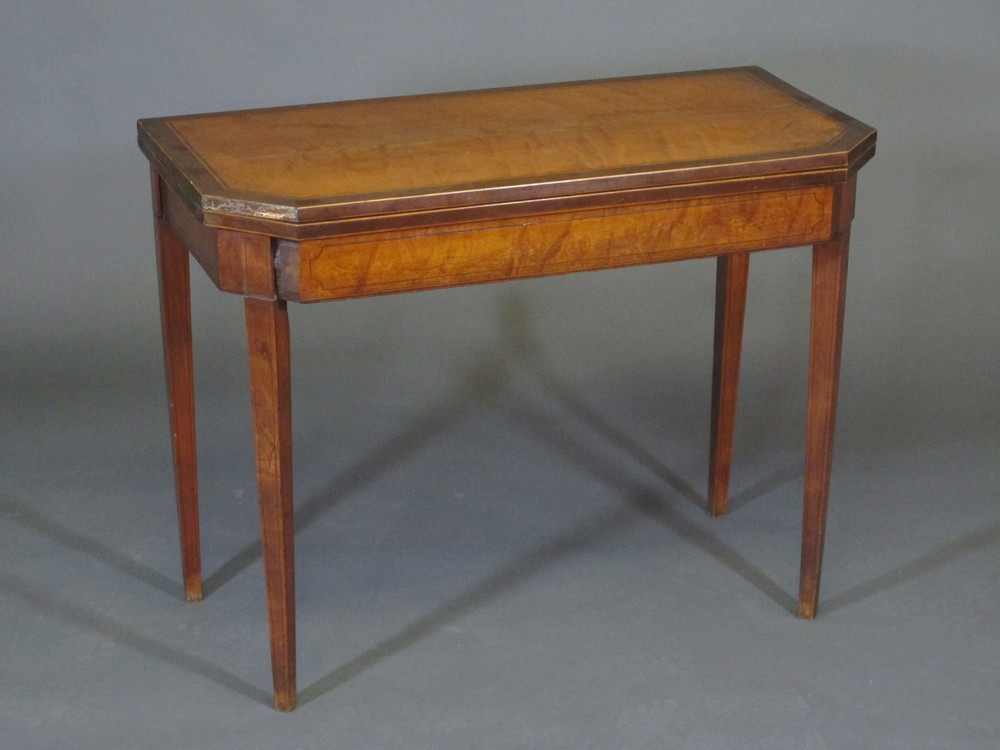 A Georgian lozenge shaped satinwood card table raised on square tapering supports 36"w x 27 1/2"h