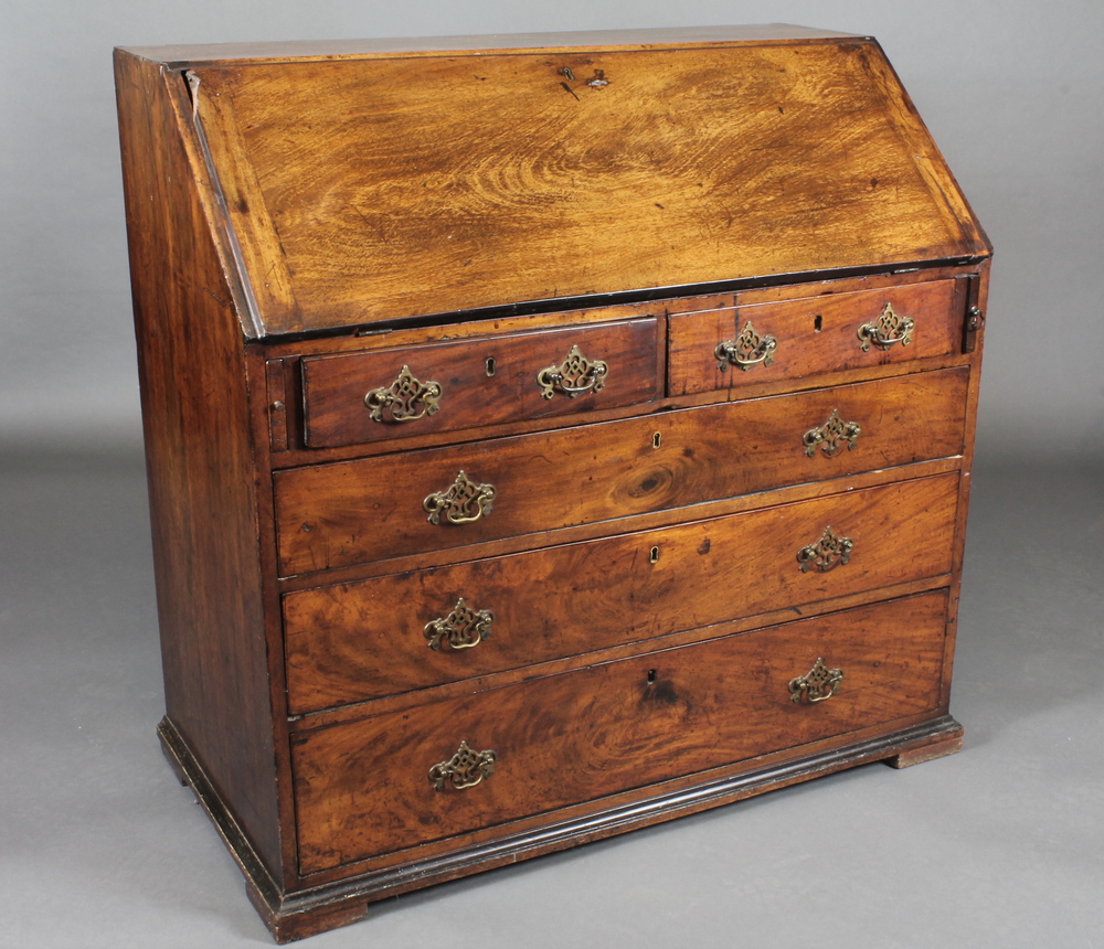 An 18th Century mahogany bureau the fall front revealing a well  fitted stepped interior above 2