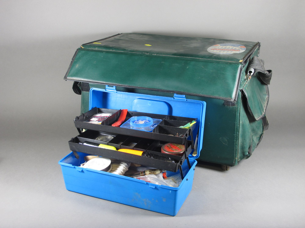 A blue plastic cantilever box containing various fishing  equipment and a green plastic fishing