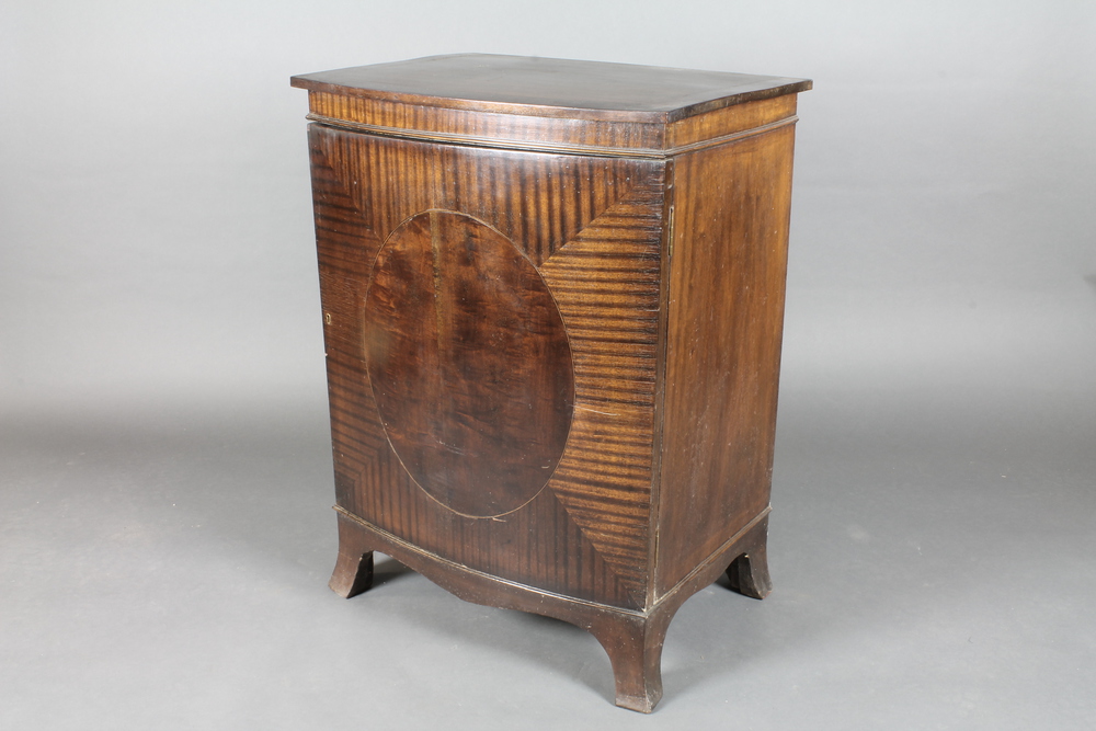 A 19th Century mahogany bow front cabinet with crossbanded  top enclosed by a panelled door,