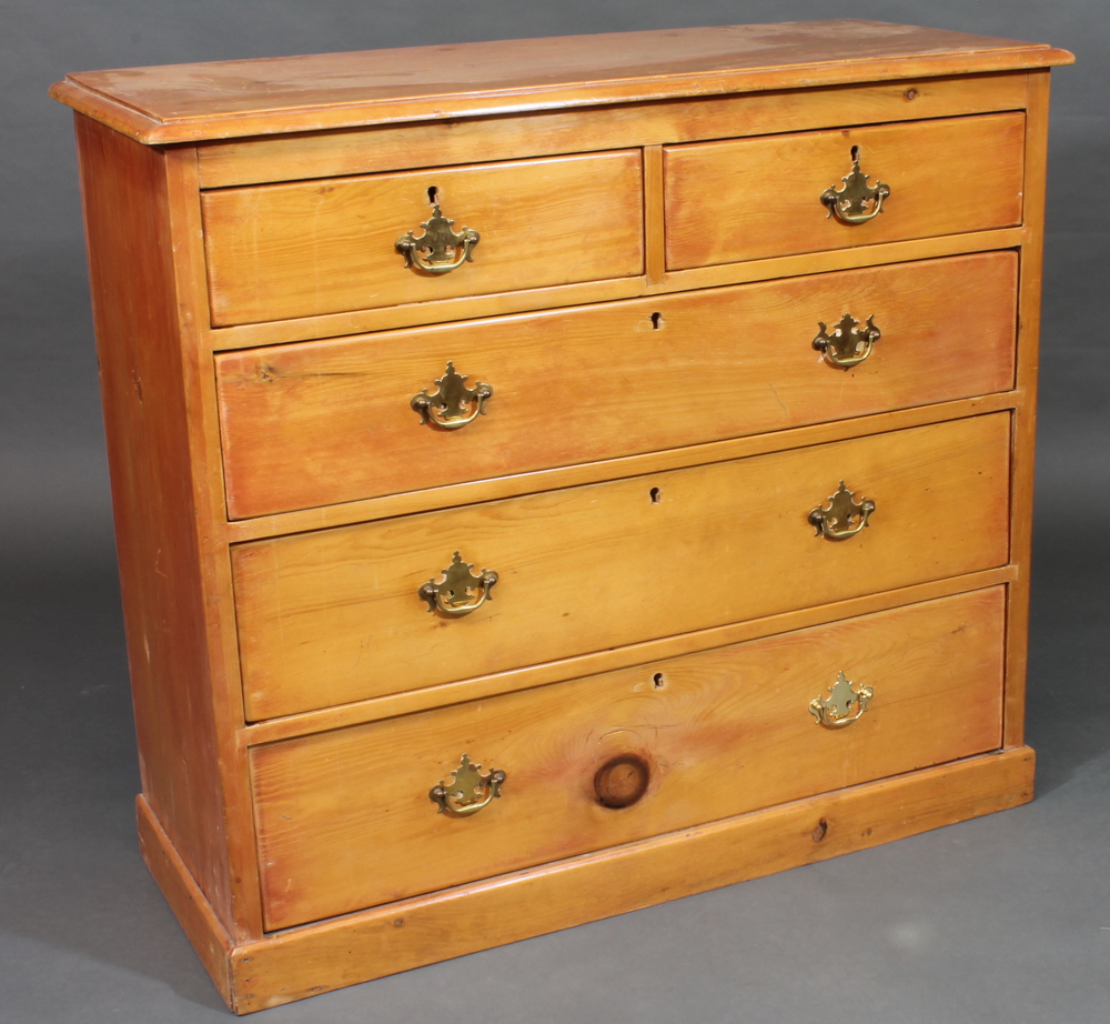 A stripped and polished pine chest of 2 short and 3 long drawers  with brass swan neck drop handles,