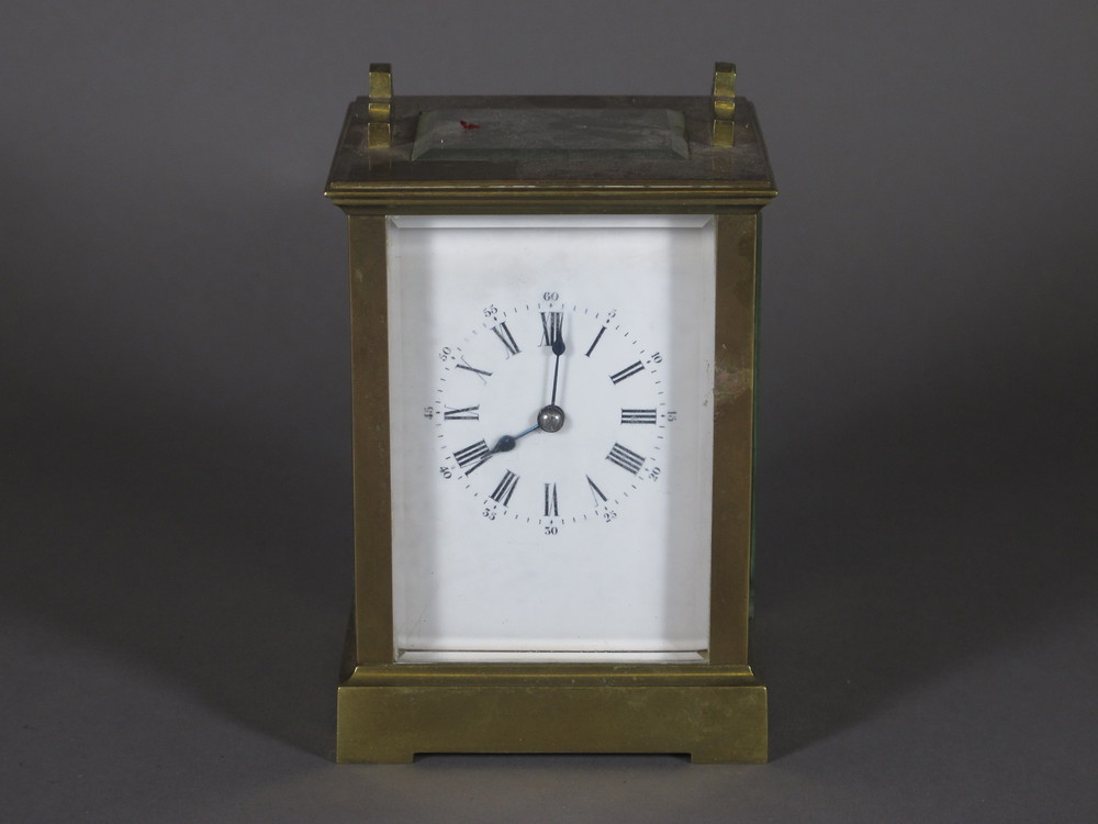 An 8 day carriage clock with enamelled dial contained in a gilt metal case, handle missing,