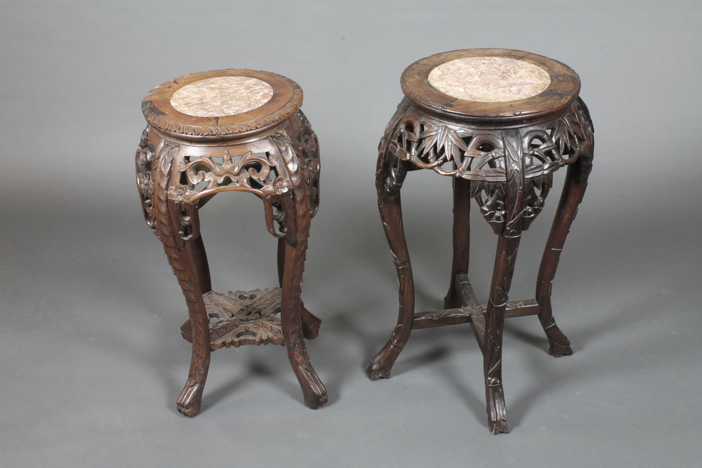 A circular pierced carved Chinese hardwood jardiniere stand with  a pink veined marble top 12" 23"
