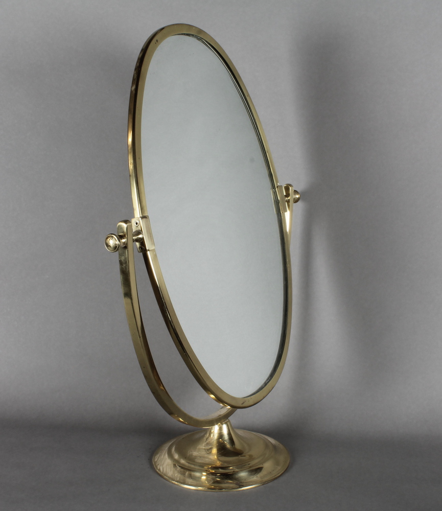 An oval plate dressing table mirror contained in a gilt swing  frame 16"