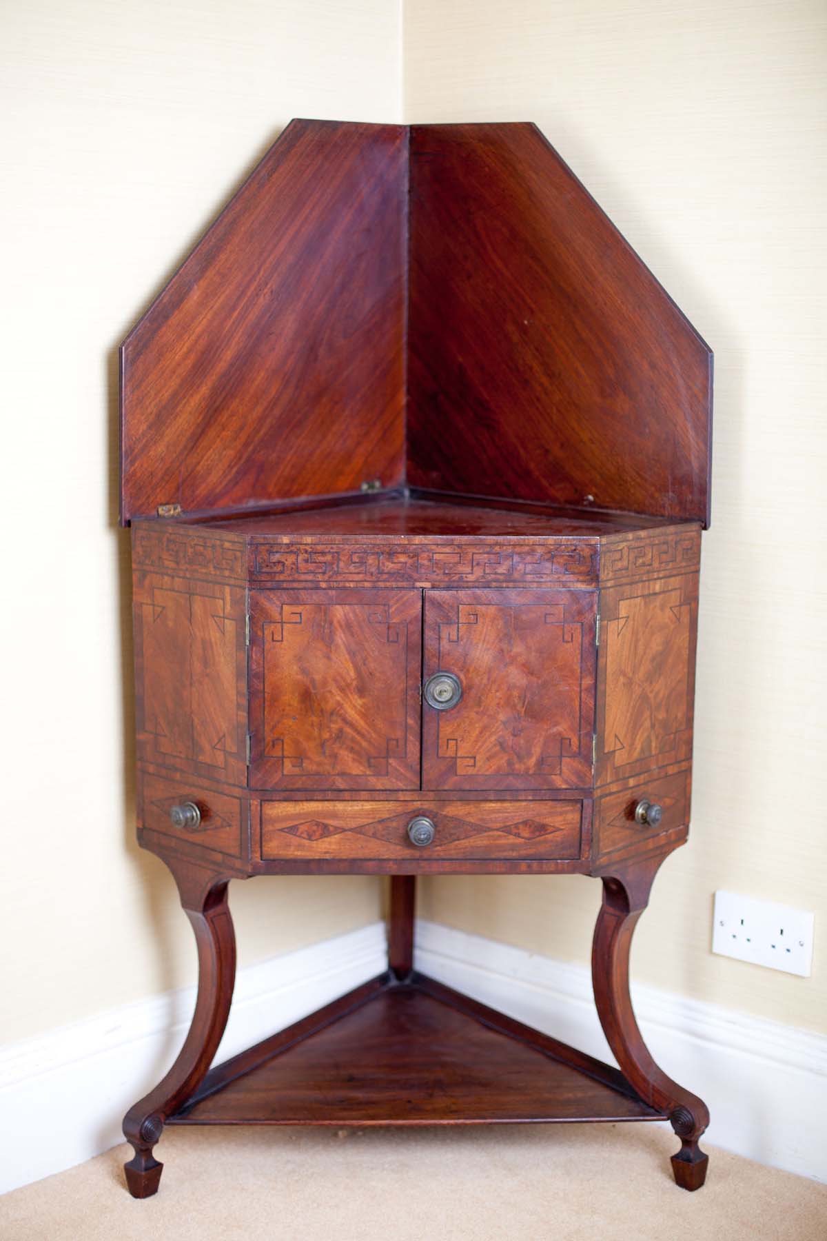 A PAIR OF GEORGIAN MAHOGANY CABINETS, c.1800, with ebony greek key inlay and rise and fall backs.