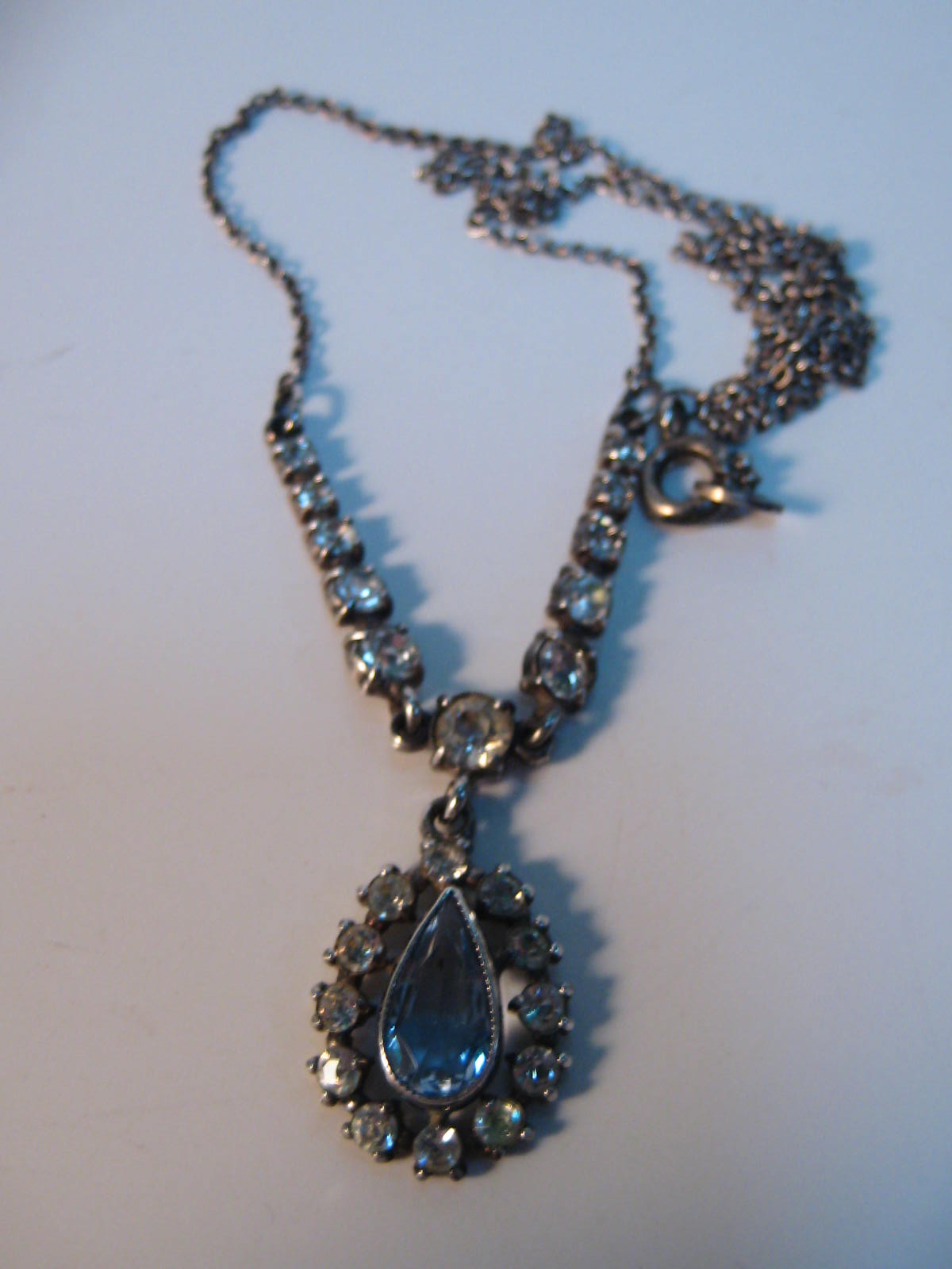 A fine silver chain with blue stone pendant