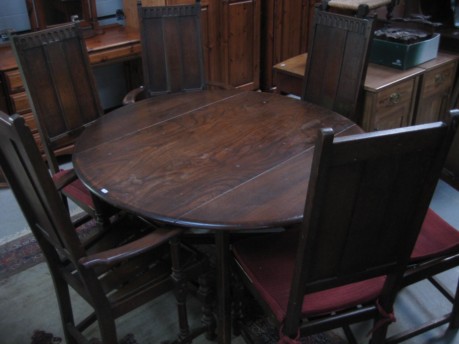 An Ercol dining suite comprising table and eight chairs