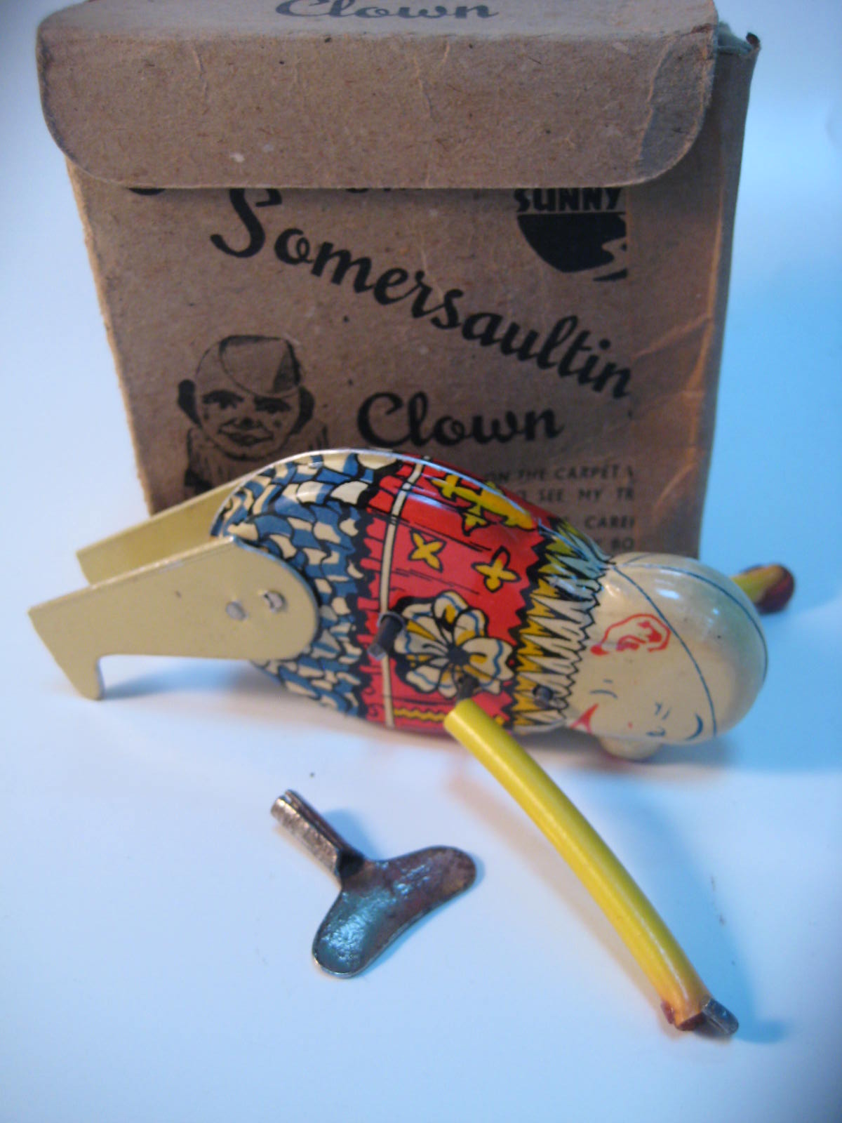 An old boxed clockwork somersaulting clown toy