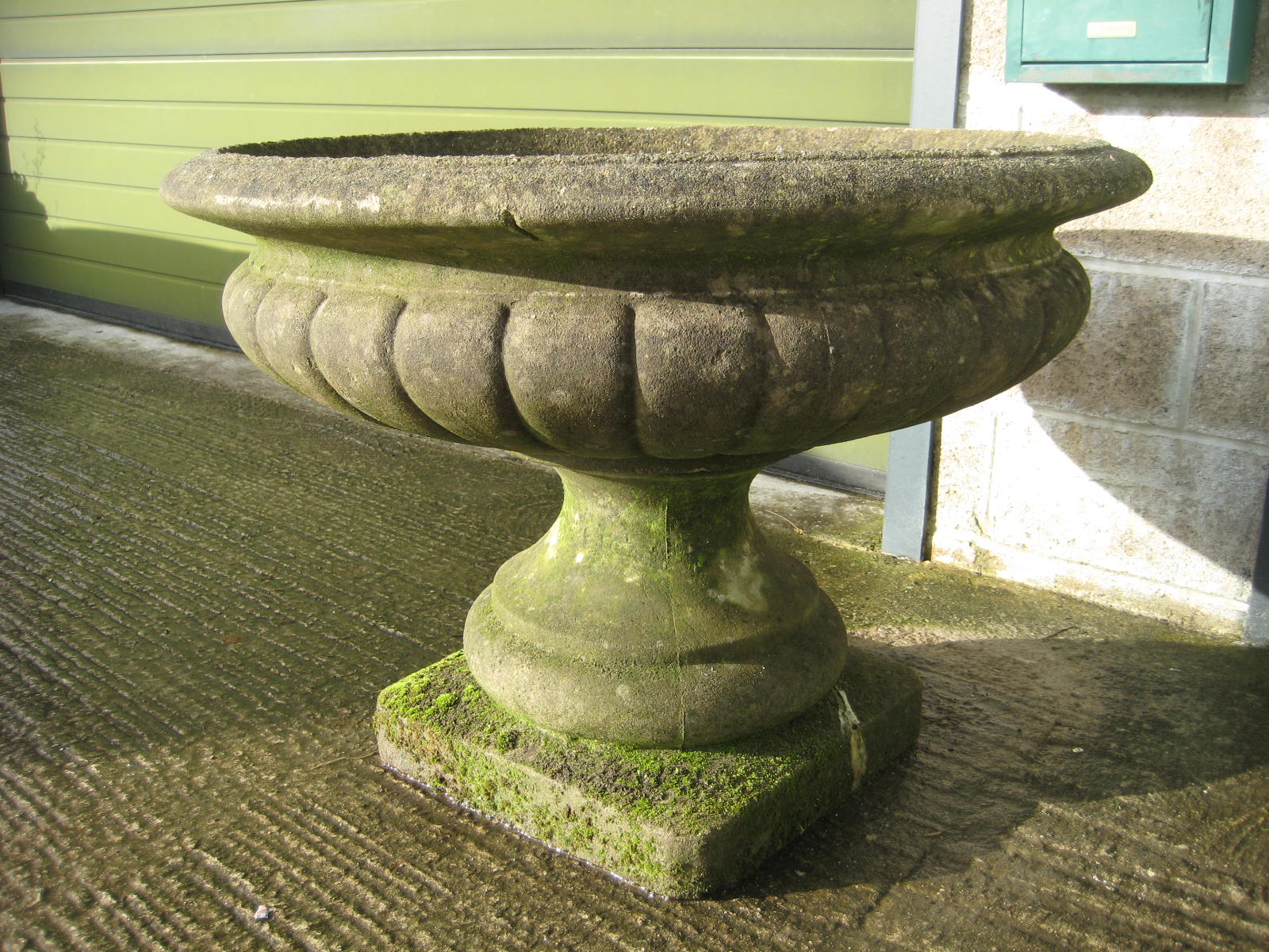 A large weathered stone garden pedestal urn 95cms diam.